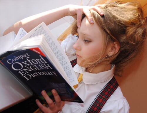 Girl reading Oxford English dictionary