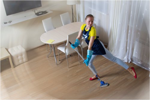 woman cleaning with a broomstick