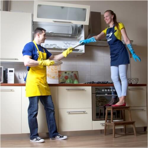 man and woman cleaning kitchen