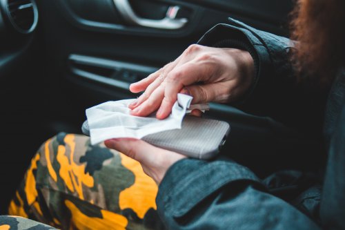 woman wipes her phone clean